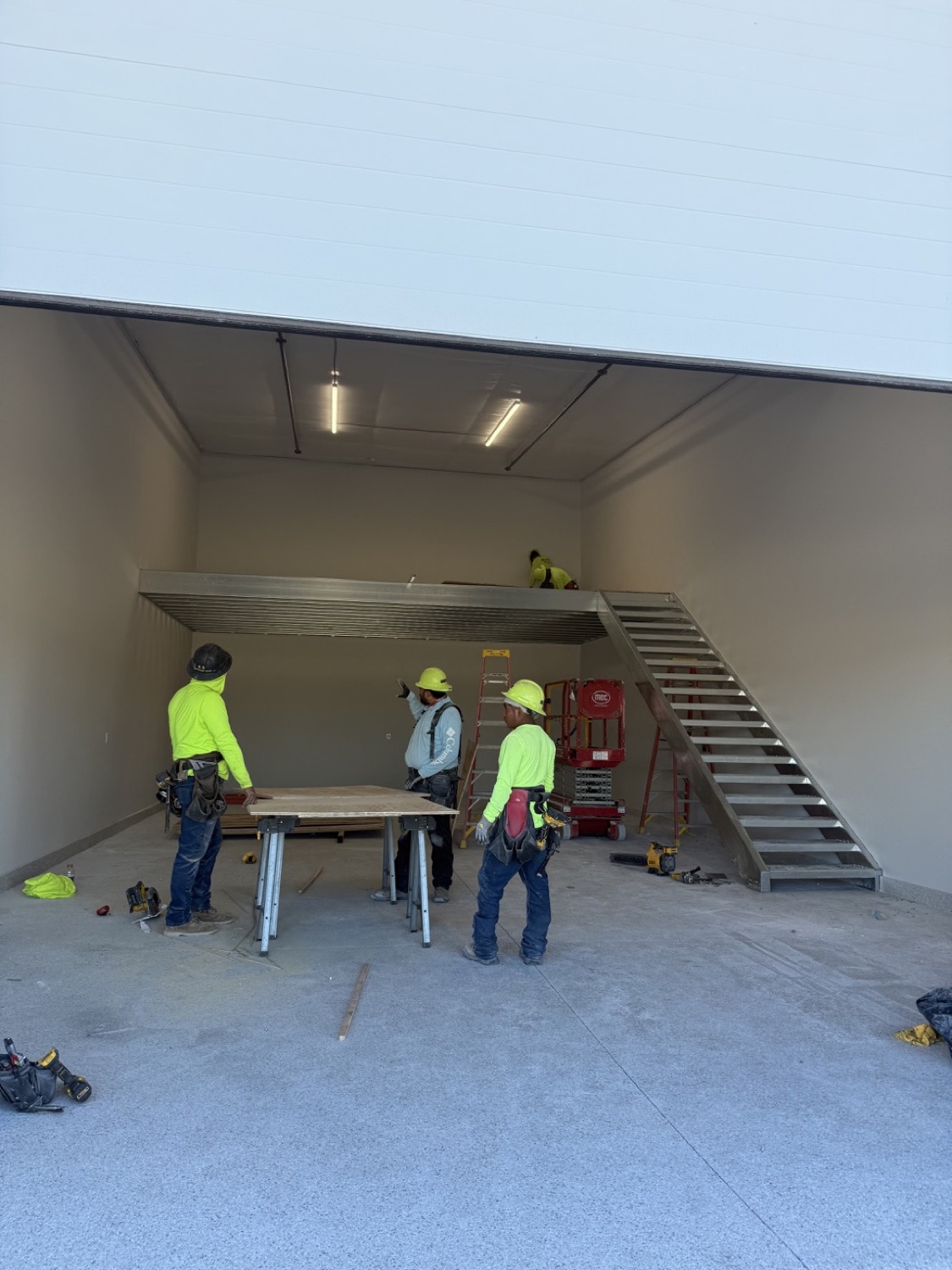 Mezzanine stairs placed on the opposite side of a garage condo